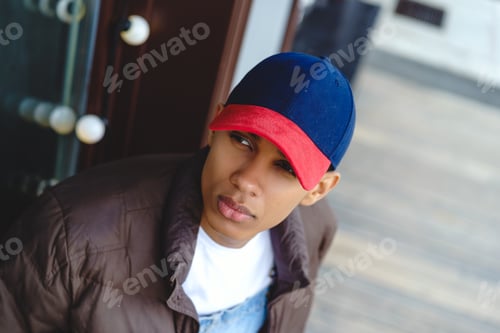 Preview: Thoughtful young man wearing cap in city