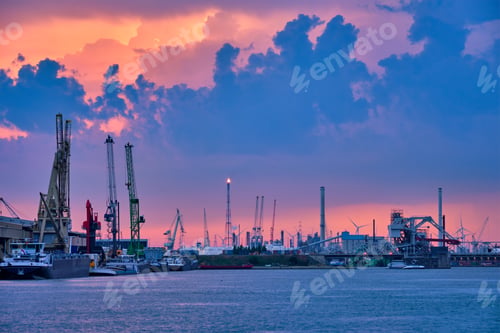 Preview: Port of Antwerp with harbor cranes in the evening