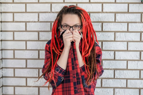 Preview: Surprised Girl With Dreadlocks Hipster In A Plaid Shirt Covered Her Mouth With Both Hands. Map Of