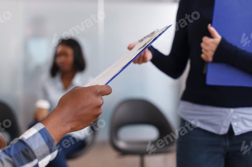 Preview: Close up of african american man hands giving employment department manager CV resume and job