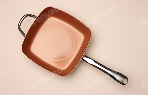Preview: New copper deep frying pan on a beige background, top view