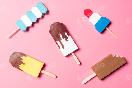 Preview: top view of various handmade colorful origami ice cream on pink