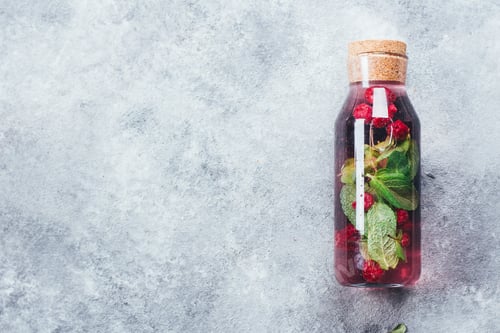 Preview: Homemade raspberry mint black currant lemonade in glass bottle. Summer healthy drink