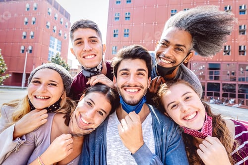 Preview: Multiracial friends taking selfie with opened face mask at college campus