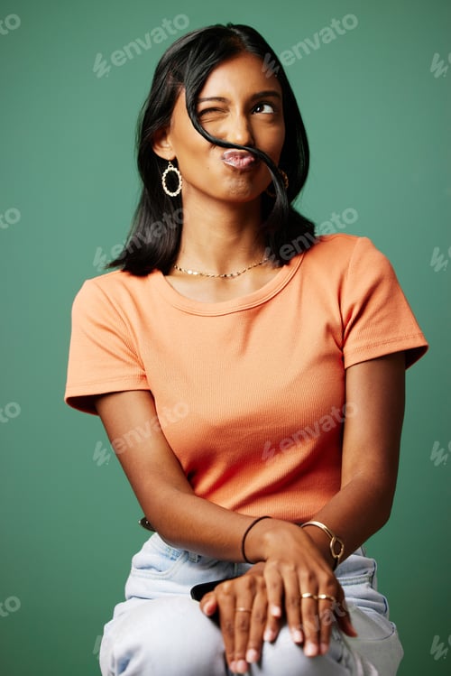 Preview: Its good to let go. Shot of a woman making a funny face shot against a studio background.