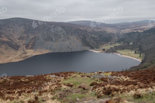 Preview: Beautiful view of a small calm lake surrounded by mountains