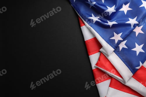 Preview: USA flag on black background, top view. Space for text