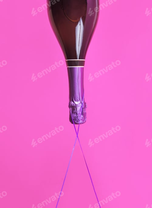 Preview: Champagne bottle upside down floats on bold color