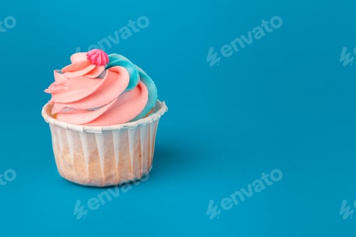 Preview: Birthday cupcakes on blue background close up