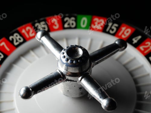 Preview: Closeup shot of a casino roulette wheel on a black surface