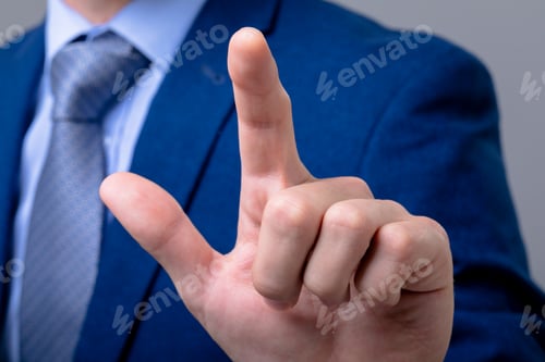 Preview: Midsection of caucasian businessman touching virtual interface, isolated on grey background