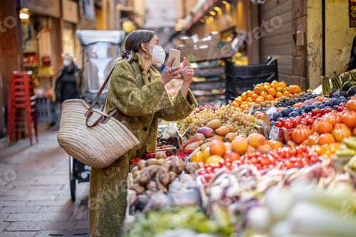 Preview: Woman buying food on the street market during pandemic