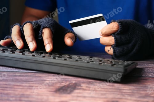 Preview: hacker hand stealing data from credit card