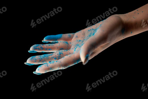 Preview: cropped view of adult woman with blue holi powder isolated on black