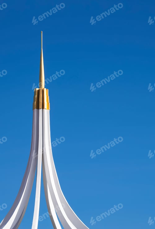 Preview: Part of curve line pattern of white and golden spire on top of building against blue clear sky