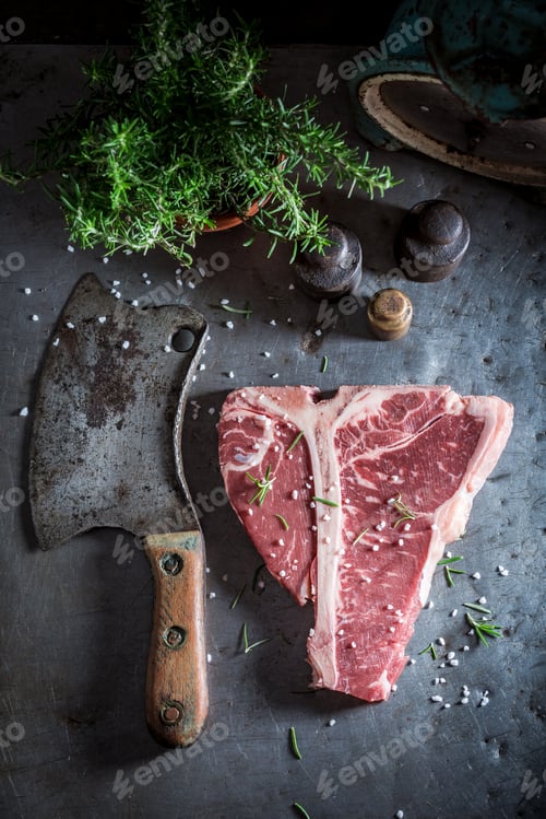 Preview: Bloody red steak on old metal table