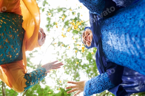 Preview: Female friends throwing flower petals