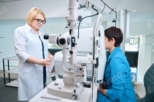 Preview: Ophthalmic professional determining patient refractive power with autorefractor