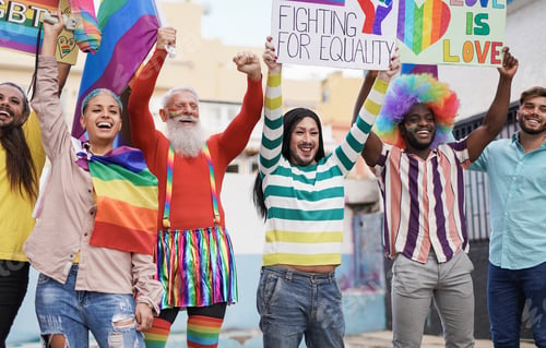 Preview: Multiracial people with banner and lgbt rainbow flag at gay pride parade