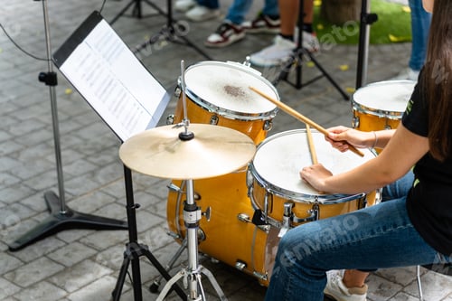 Preview: Female musician percussionist playing drums
