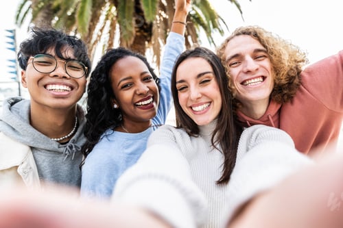 Preview: Multicultural cheerful friends taking selfie pic with smart mobile phone device