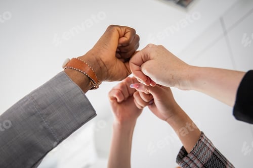 Preview: Joined fists of businesspeople of different ethnicities together