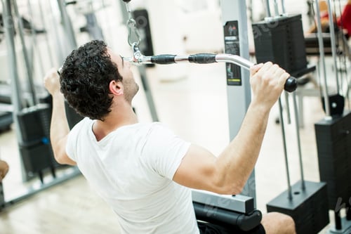 Preview: Young man training in the gym