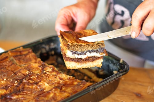 Preview: Midsection of woman holding slice of cake