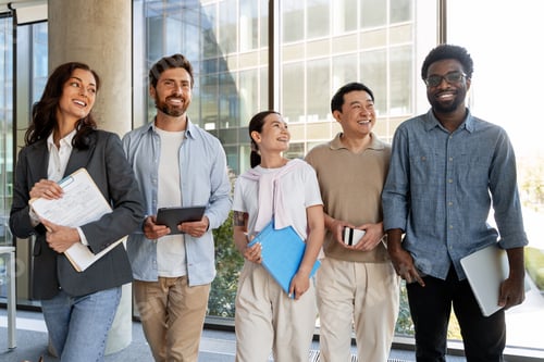 Preview: Multicultural businesspeople walking together in modern office corridor