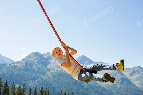 Preview: Boy playing on swing, Tyrol, Austria