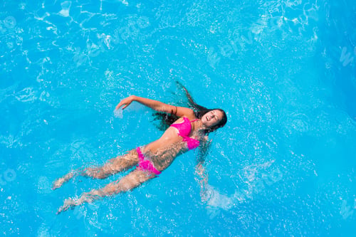 Preview: A girl is relaxing in a swimming pool
