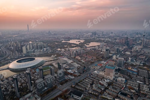 Preview: Aerial shot of Tianjin TV Tower and Water Park Complex near water in China at sunset