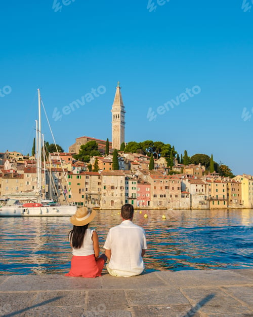 Preview: A couple enjoys a serene moment by the waterfront in Rovinj, Croatia on a sunny day