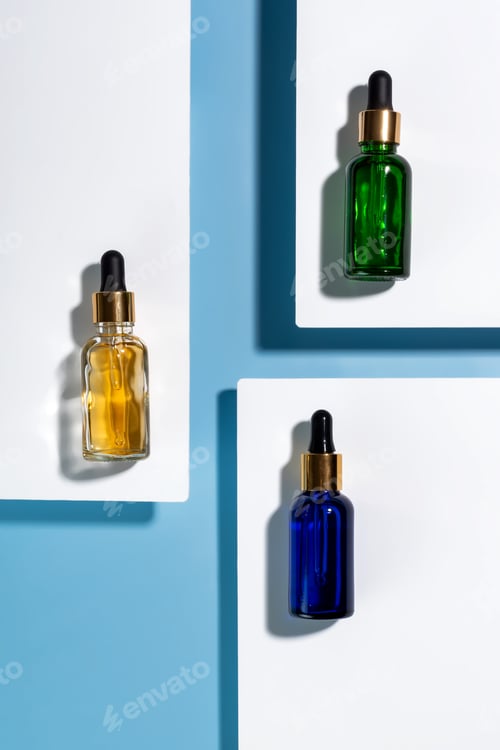 Preview: Beauty collagen face serum in a glass dropper bottles on double white and blue background. Trendy