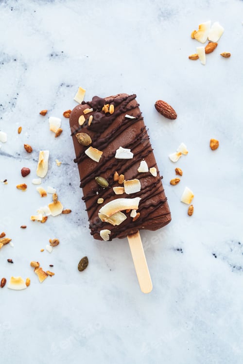 Preview: Vegan chocolate popsicle on stick. Summer dessert, plant-based concept.