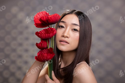 Preview: Vibrant confident skincare model posing with a carnations bouquet
