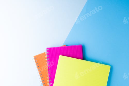 Preview: Three notebooks with binding and copy space on blue background
