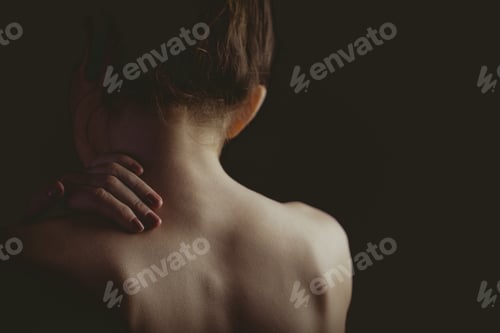 Preview: Back View of Woman with Hand on Neck