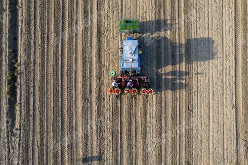 Preview: Overhead aerial view of agricultural workers in tractor with automatic tomato planter machine