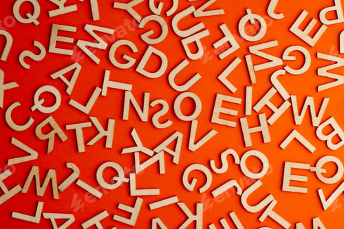 Preview: wooden cut alphabet letters on orange background