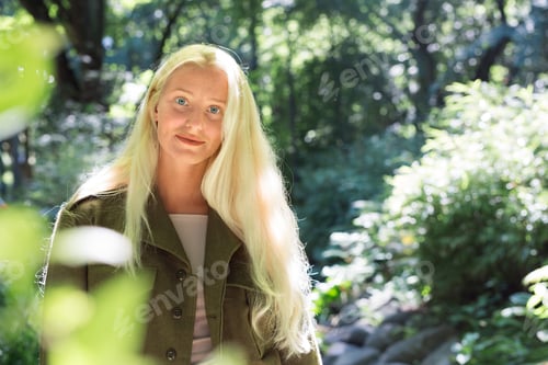 Preview: Teenage girl (16-17) among trees in park