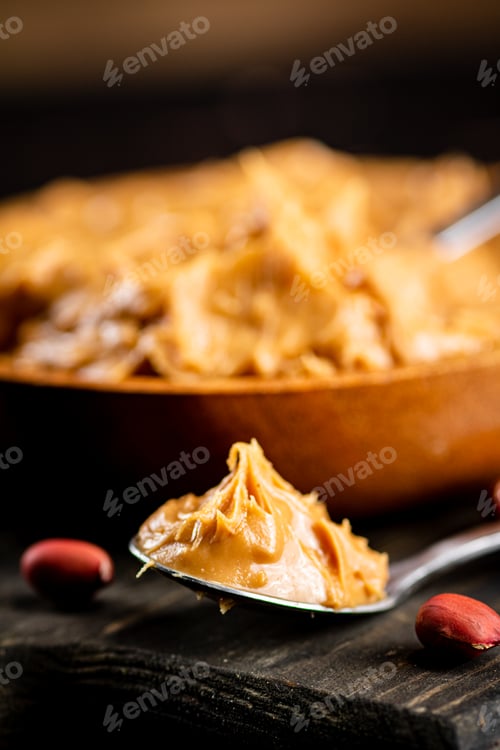 Preview: Peanut butter in a spoon on a cutting board.