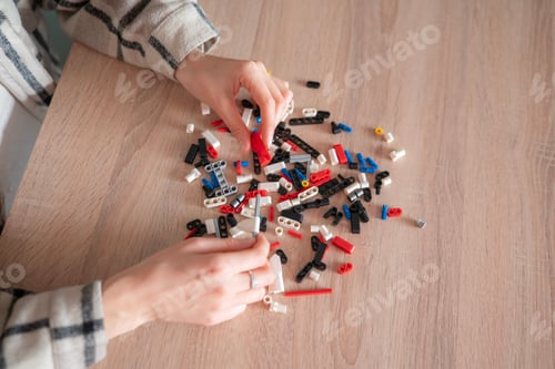 Preview: Child focuses on assembling various shapes with construction blocks