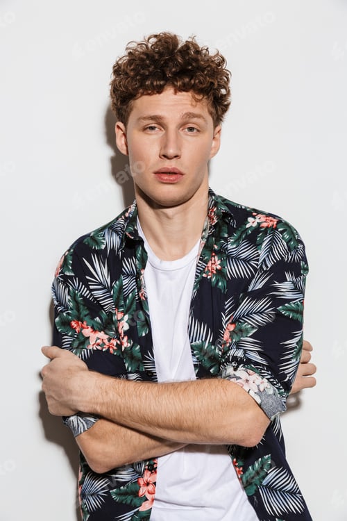 Preview: Image of curly handsome man posing and looking at camera