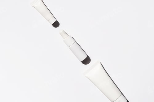 Preview: Minimalist white skincare tubes and dropper mock up on white background.