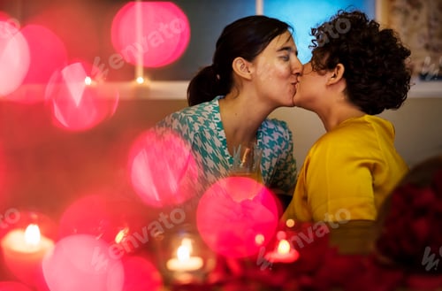 Preview: Lesbian couple kissing during dinner