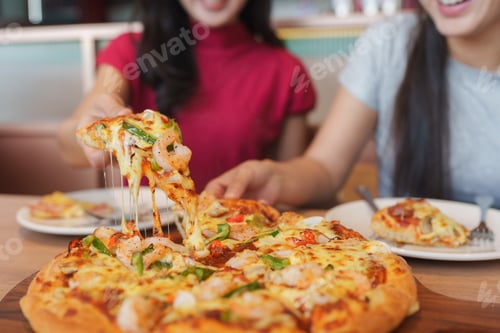 Preview: Friends sharing shrimp pizza at a casual restaurant