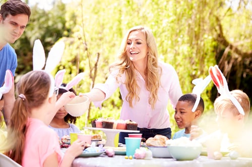 Preview: Parents With Children Wearing Bunny Ears Enjoying Outdoor Easter Party In Garden At Home