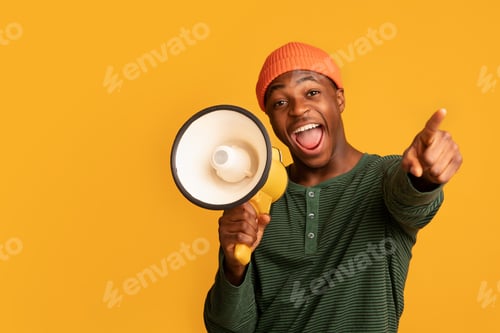 Preview: Cheerful Black Guy Shouting In Loudspeaker And Pointing At Camera