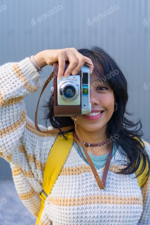 Preview: Portrait of a young Asian woman photographing with a vintage photo camera, vacation concept, tourist